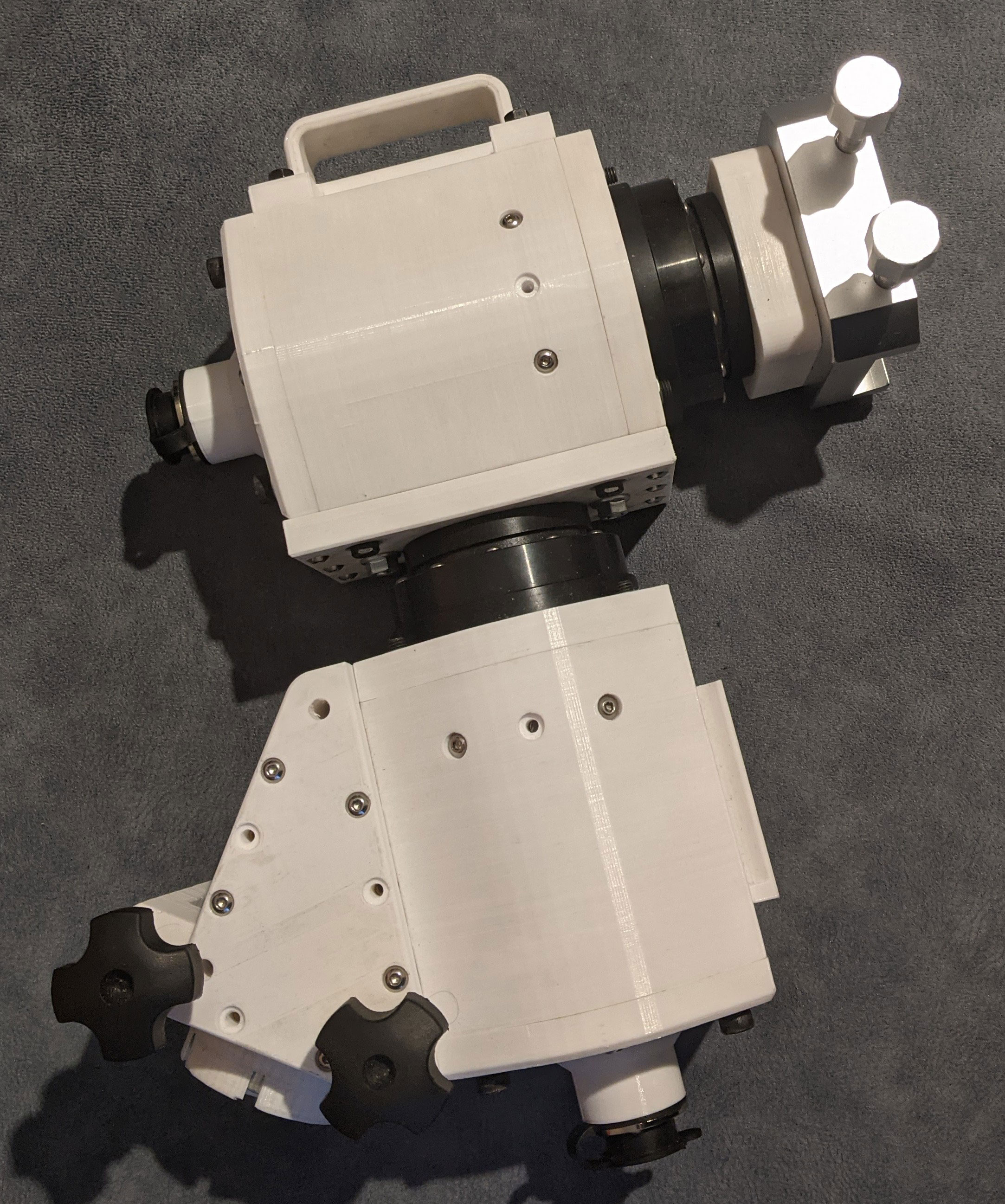 The mount on its side showing the handle for carrying