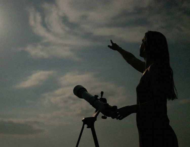 Astronomer on a cloudy evening